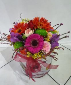 Colorful and happy flower box with mini gerberas, astromeries, margaritas, mini roses and decoration