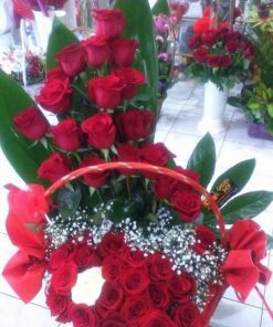 40 red and 1 white rose in a basket with greenery