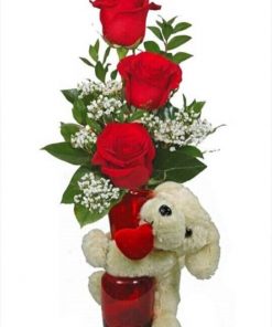 3 red roses with accompanying decoration in a glass flask and plush honey