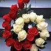 An interesting arrangement with 12 red and 11 beautiful roses
