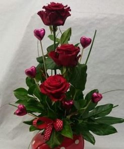 Cute arrangement with 3 red roses, small hearts and decoration